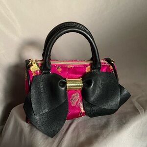 Betsey Johnson cylindrical handbag 

In great condition with super detailed silk